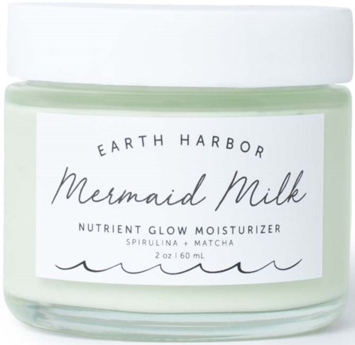En burk med Earth Harbor Mermaid Milk-kräm med etikett som visar smaken spirulina och matcha. Vit lock och pastellfärgad behållare.