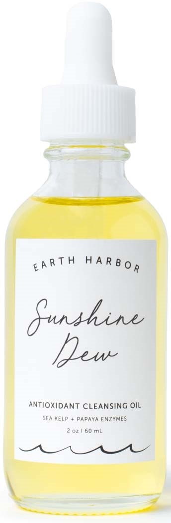Een kleine glazen fles met een witte pipethouder bevat gele olie. Label zegt 'Sunshine Dew' van Earth Harbor.