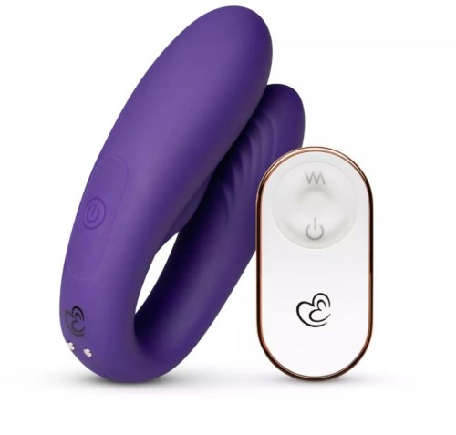 A purple, curved device with buttons and a remote control, likely a personal massager or sexual wellness product.