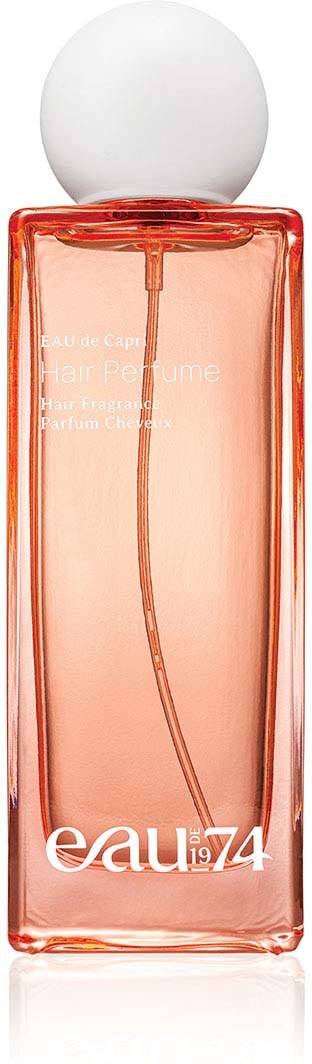 A tall pink perfume bottle with a white round cap and clear label showing text.