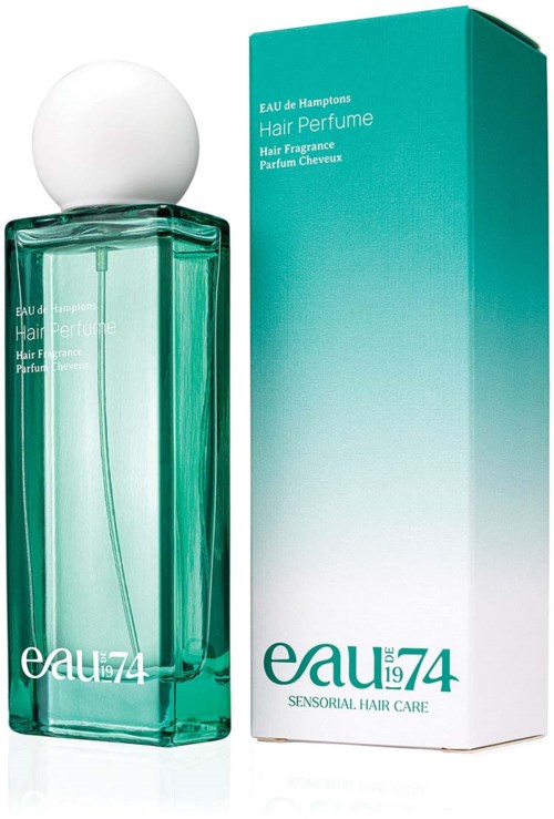 A teal bottle of hair perfume next to its matching box, labeled Eau 74. The bottle has a white cap.