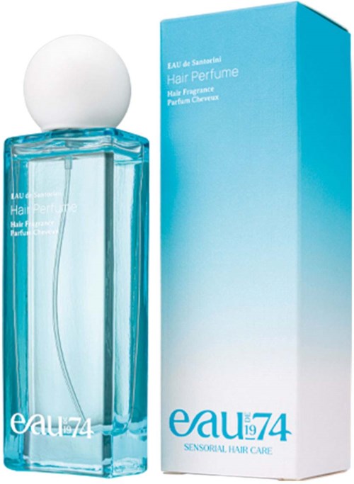 A rectangular light blue perfume bottle with a round white cap, next to a matching box. Label says "Eau 74".