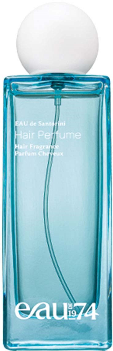 A tall blue glass bottle with a white spherical cap, labeled 'eau 74' and 'Hair Perfume'.