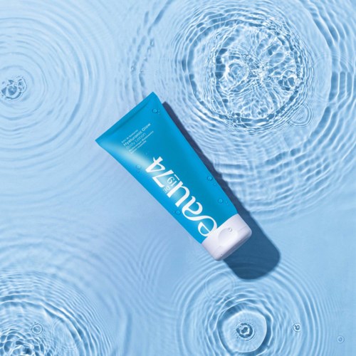 A blue tube of sunscreen floating on water with ripples surrounding it.