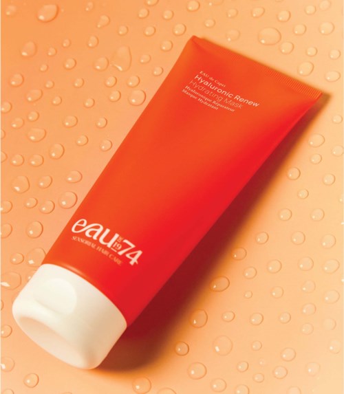 A red tube labeled 'eaut74' on a peach background with water droplets.