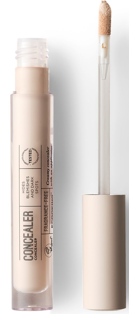En concealer-pakke med applikatorstav, viser at låget er fjernet og produktet er delvist synligt.