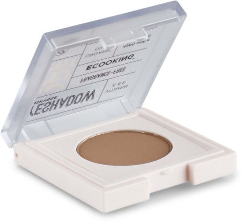 En liten kakpalette med ljusbrun pressad puder inuti och ett genomskinligt lock som öppnas.