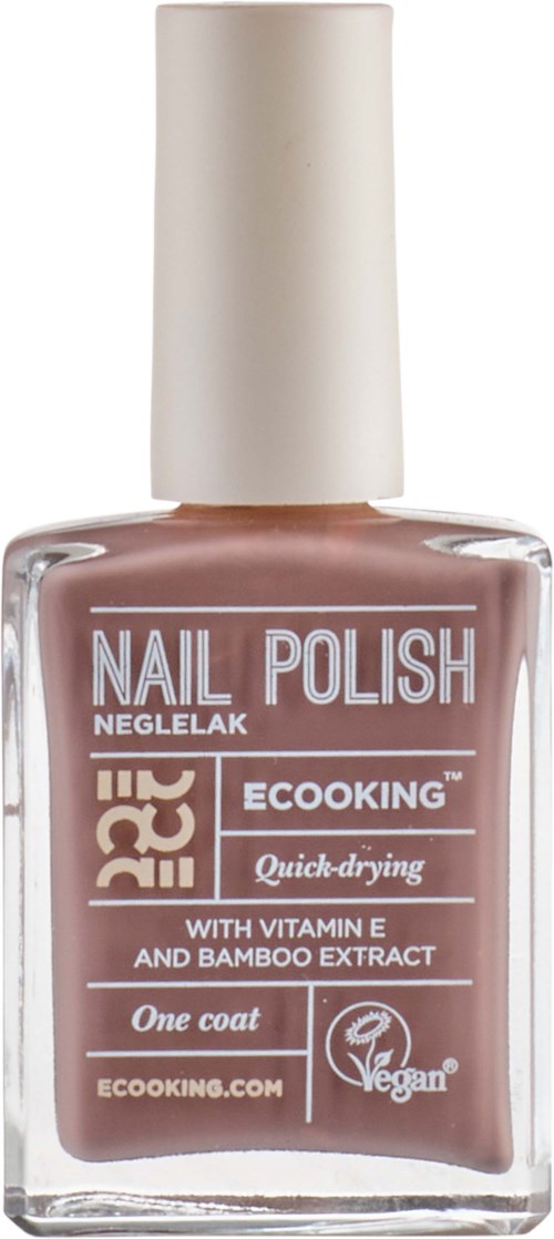 A bottle of nail polish with beige color, white cap, labels indicating vegan, quick-drying, with vitamin E and bamboo.