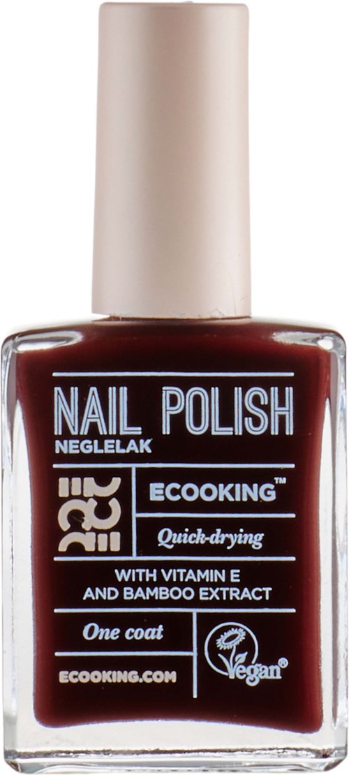 A bottle of dark red nail polish labeled 'Nail Polish' with a white cap, featuring vegan and quick-drying claims.