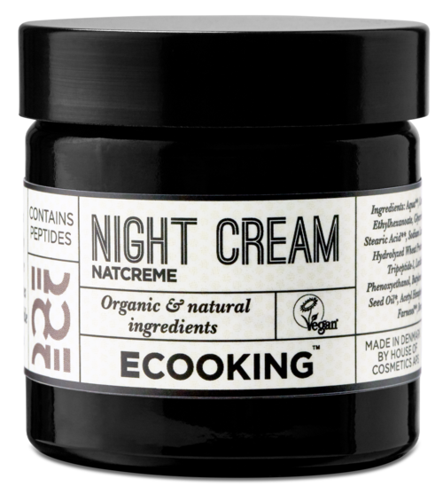 En svart burk märkt 'Night Cream' med naturliga ingredienser, vegansk, till hudvård på natten.