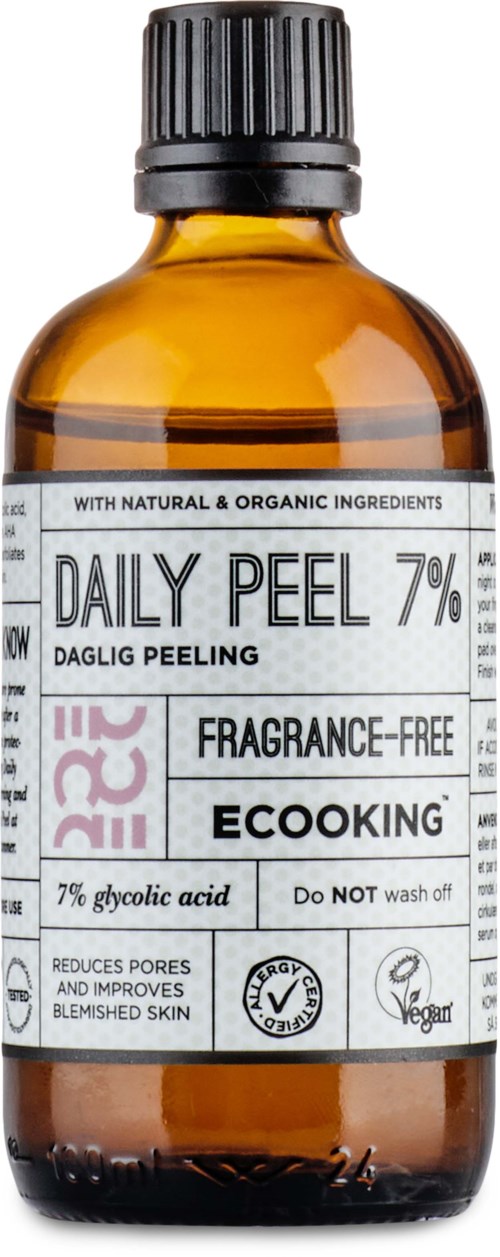 Brun glassflaske med svart lokk, etikett viser daglig peeling, parfymefri, miljøvennlig, reduserer porer.