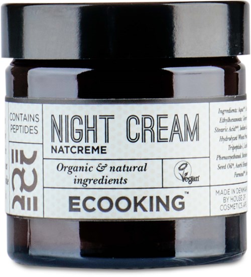 En mörk burk med etiketten 'Night Cream' med naturliga ingredienser och vegankrav. Den innehåller peptider och är organisk.