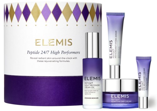 A set of skincare products, including creams and oils, with purple, silver, and white packaging, and a patterned box.