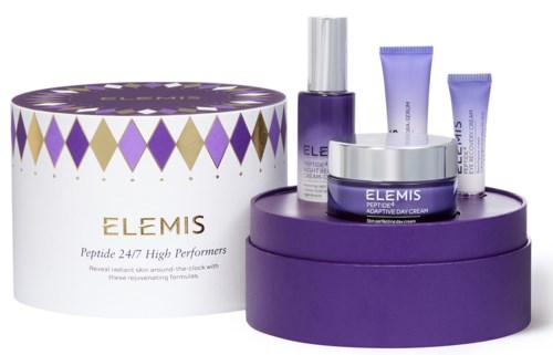 A set of skincare products in purple containers and a white box with gold and purple diamond patterns.