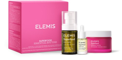 Skincare products: a pink box, a pump bottle, a dropper bottle, and a jar with labels, all parts of the Elemis Superfood line.