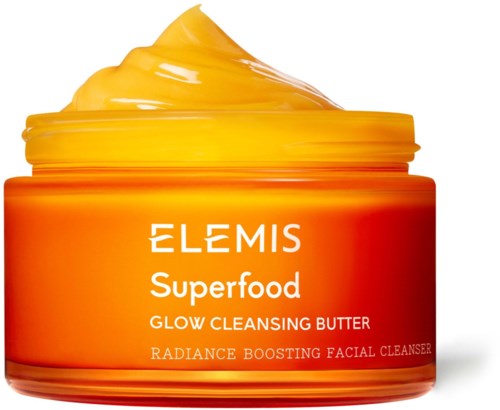 A jar of orange-yellow glow cleansing butter, labeled as Elemis Superfood, for face cleansing and skin glow.