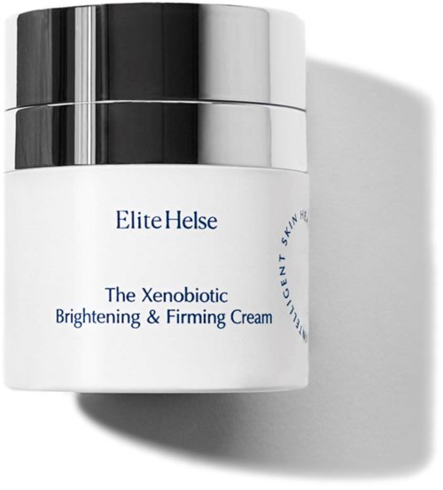 En vit burk med svart och silverlock, märkt "Elite Helse" och "Brightening & Firming Cream."
