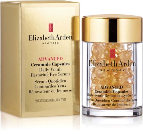 Przezroczysty złoty pojemnik z kapsułkami obok złotej pudełka, seria do oczu Elizabeth Arden.