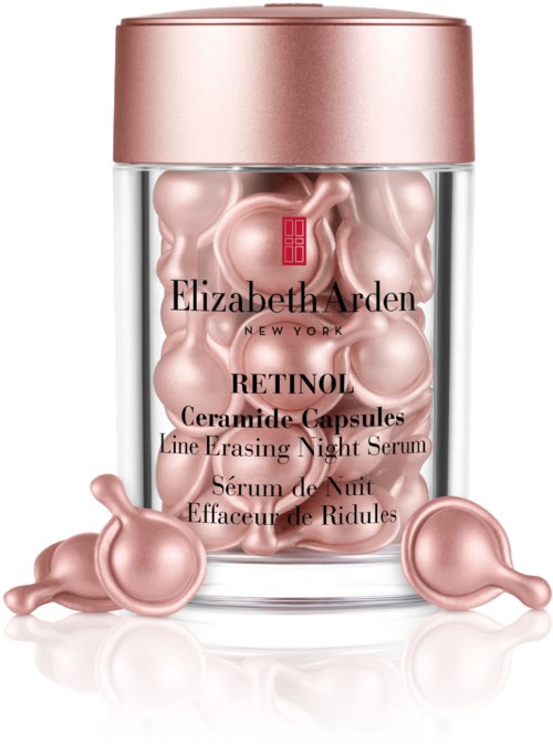 Lasipullossa pinkkejä kapselikokoelmia ja ruusukullan värinen kansi, merkitty Elizabeth Arden Retinol Ceramide Capsules yöksi.