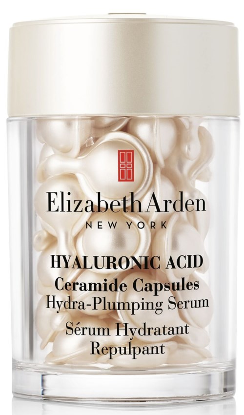 En klar beholder med hvide kapsler, mærket Elizabeth Arden Hyaluronic Acid Ceramide Capsules, Hydra-Plumping Serum.