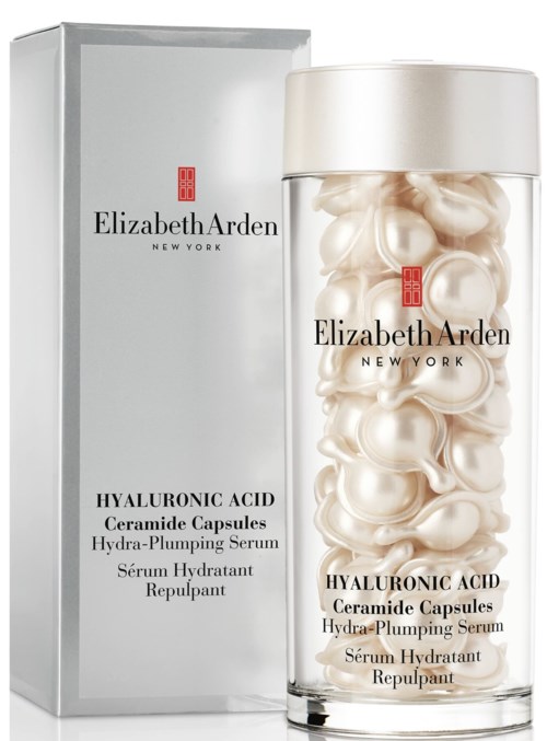 En tydlig flaska med vita kapslar och en box, märkt Elizabeth Arden hyaluronic acid ceramide capsules hydra-plumping serum.