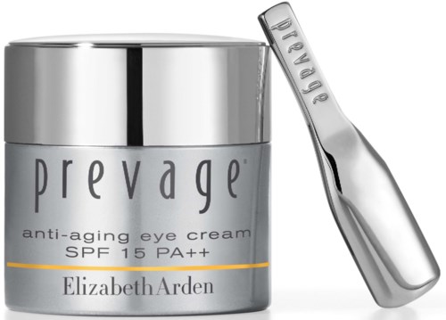 En sølvkrukke med Prevage anti-aldrings øye krem og et lite sølvapplikator verktøy. Krukken sier SPF 15 PA++.