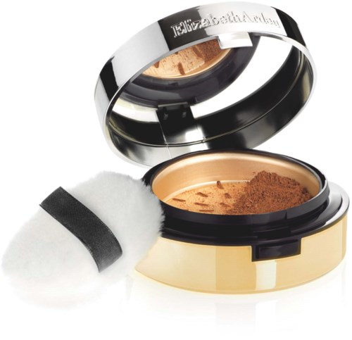 Een compact make-up poeder met spiegel en applicatorspons in een gouden geval.