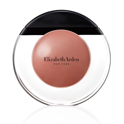 En rund behållare med svart, vitt och en rosa-beige etikett i mitten som säger Elizabeth Arden New York.