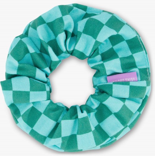 A teal and green checkered fabric scrunchie with a small purple tag.