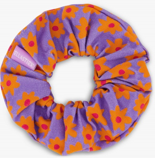 A purple fabric scrunchie with orange and pink flower patterns.