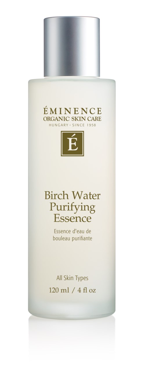 En hvit flaske med sølvhette merket 'ÉMINENCE' og 'Birch Water Purifying Essence'.