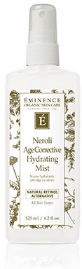 En vit sprayflaska med guld- och svart etikett, kallad Éminence Neroli Age-Defiant Hydrating Mist.
