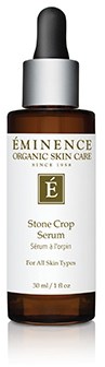 A small brown bottle with a black dropper cap containing ÉMINENCE skincare serum.