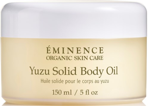 En krämfärgad burk med Eminence Yuzu Solid Body Oil, märkta som ekologisk hudvård, 150 ml, med vit lock.