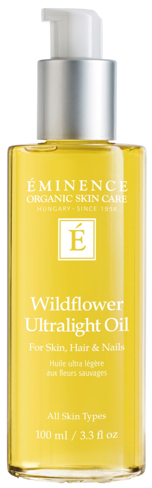 En klar flaske med gult væske, merket 'Wildflower Ultralight Oil' for hud, hår og negler, 100 ml.