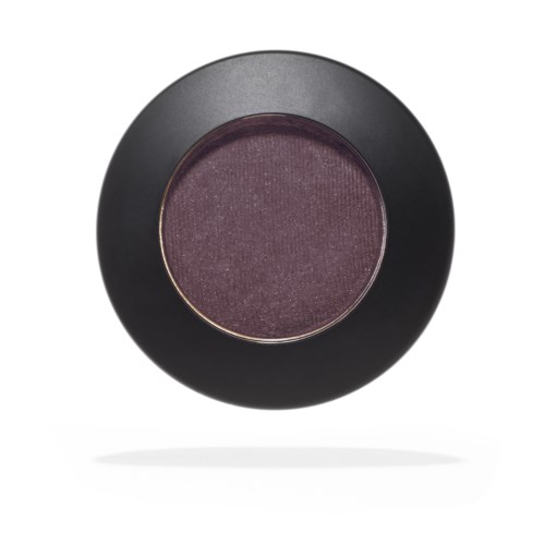 A round makeup compact with purple eyeshadow inside, black outer case, and slight shadow below.