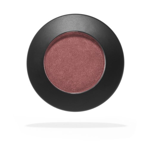 A round makeup blush in a black case with a pinkish shade, showing a slightly shimmery surface.