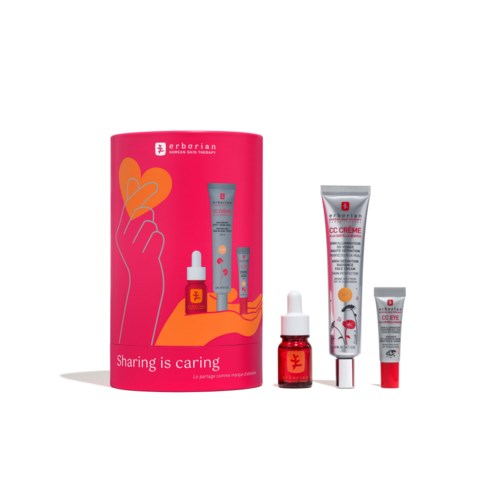 A set of skincare products with a pink container and three small tubes, some with dropper and tube caps.