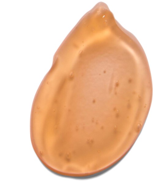 En blank, glat, beige-agtig genstand med dråbeform og nogle små fregner eller pletter på overfladen.