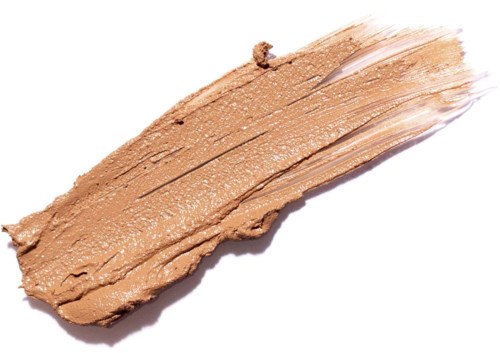 Creat, beige makeupprodukt spredt i en stribe på hvid baggrund.