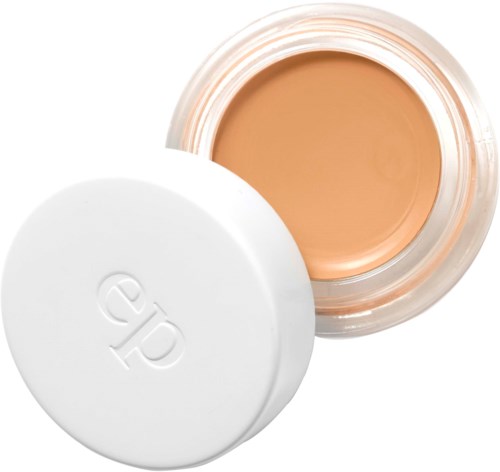 En lille krukke med beige farvet creme indeni, og et hvidt låg med logo.