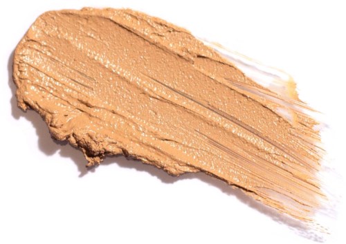 Et strøg af beige makeup med pulveragtig tekstur og lidt shimmer, spredt på en hvid baggrund.
