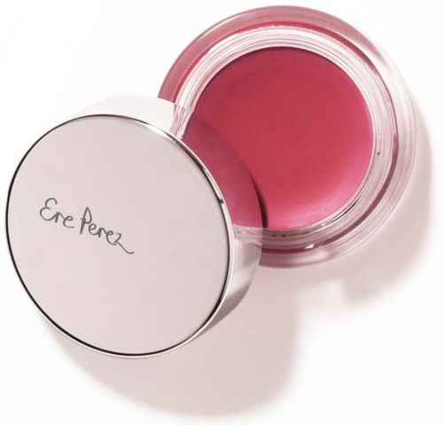 A pink blush or makeup product in a clear round container with a white lid. The lid has the brand name, Ere Perez.