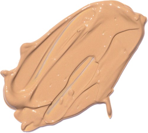 En beige cremet substans, spredt i et tykt lag med nogle ujævne streger og små bump.