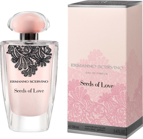 A perfume bottle with a pink liquid, a black lace design, and a pink box with floral patterns and text.