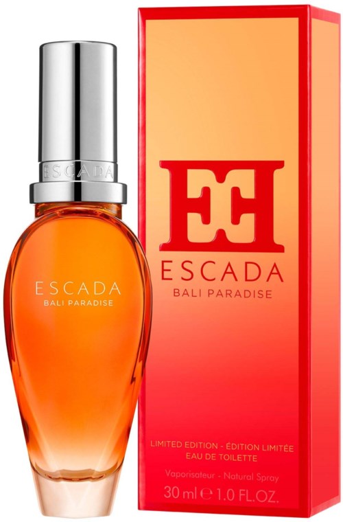 Butelka perfum z pomarańczową zawartością i srebrnym korkiem, obok czerwone i pomarańczowej pudełko z napisem 'ESCADA' i 'BALI PARADISE.'