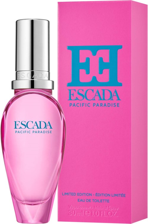 Różowa butelka perfum z srebrnym kapsułem i jasnoróżowe pudełko, oba z niebieskim tekstem ESCADA Pacific Paradise.