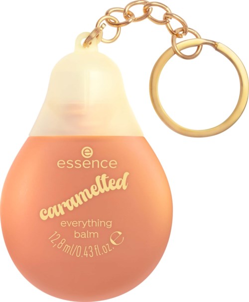 Caramellfärgad Essence everything balm i en tårformad behållare med nyckelringsdetalj, med gulddetaljer och varumärke.
