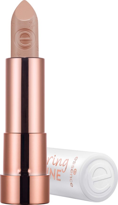 A beige lipstick with a rose gold tube and white cap lying next to it.