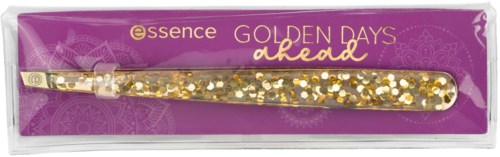 Eine goldene Haarnadel mit Glitter, in lila Verpackung mit 'essence GOLDEN DAYS didd' beschriftet und dekorativen Mustern.